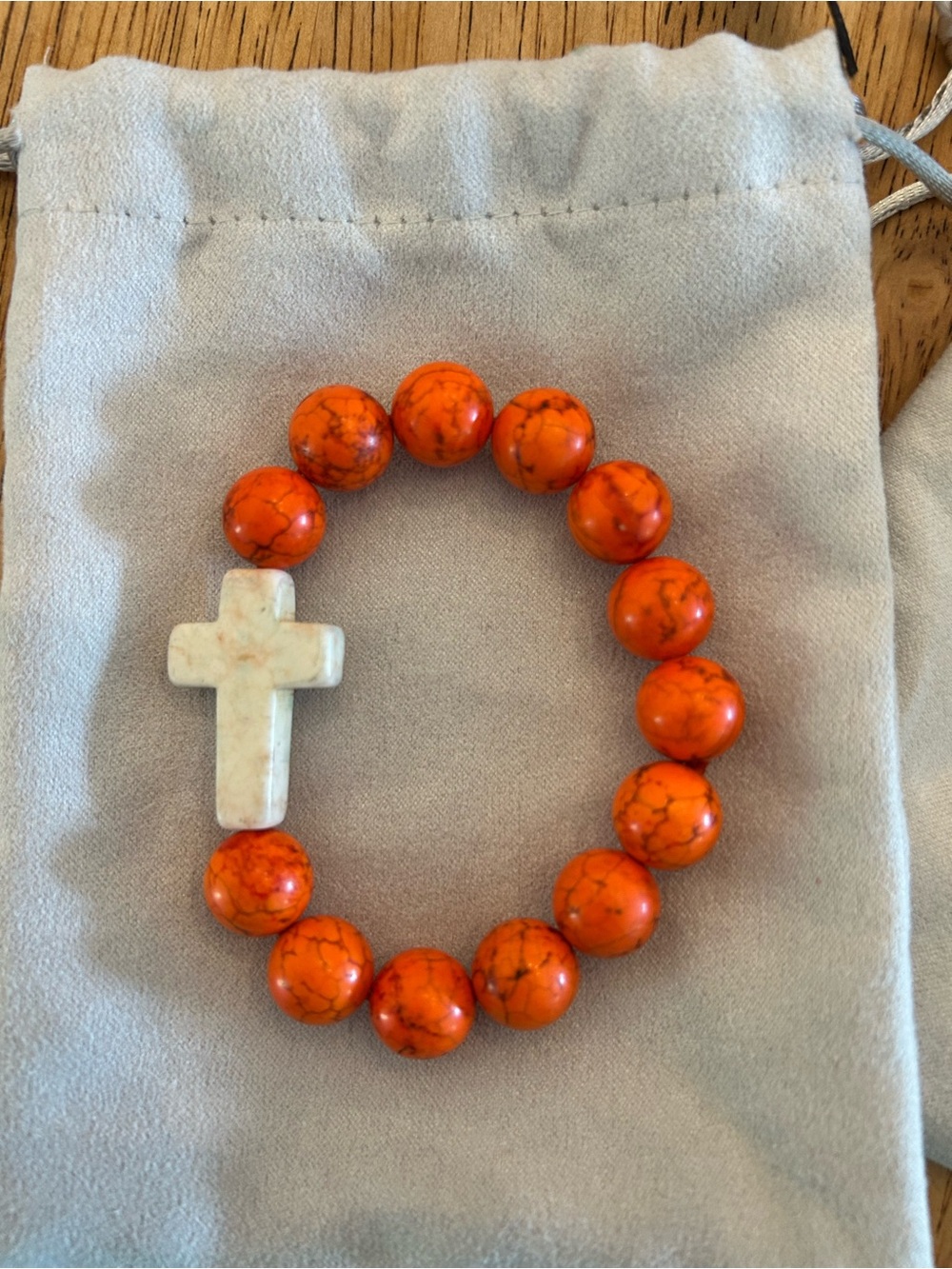 Orange Beaded Bracelet with White Cross Charm